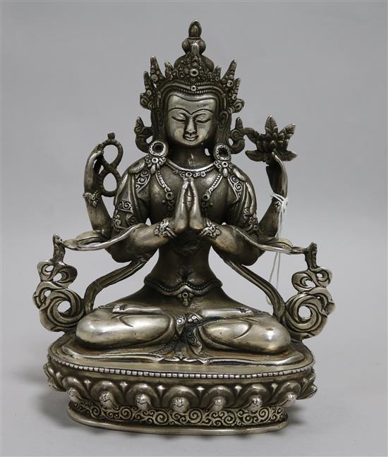 A Tibetan silvered bronze seated figure of a deity 20cm